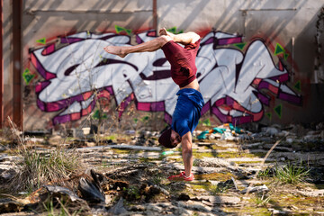 Young Athletic Man Doing Handstand at Warehouse