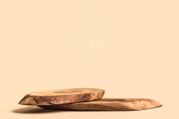 Rustic wood podium for cosmetics or perfume against beige background. Mockup.