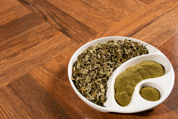 Moringa powder in wooden spoon - dried moringa leaves - moringa oleifera.