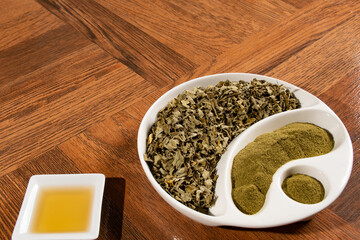 Moringa powder in wooden spoon - dried moringa leaves - moringa oleifera.