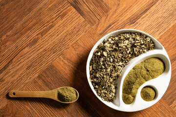 Moringa powder in wooden spoon - dried moringa leaves - moringa oleifera.