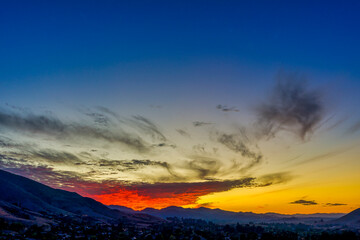 Red, yellow, blue sunrise over horizon