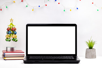 side view for a christmas workplace at office or home office. white laptop display mockup. template for christmas card