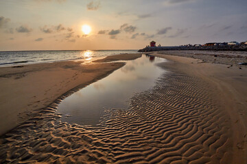 Strong natural patterns on Dutch beach during sunrise .
Scenic View Of Sea Against Sky During sunrise