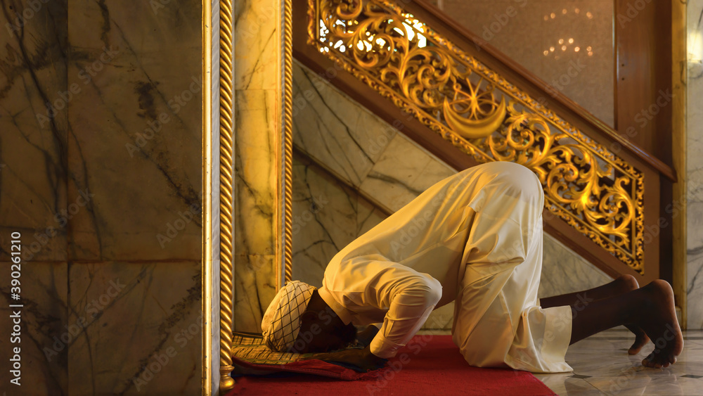 Poster muslim man having worship and praying for allah blessing in islam ceremony in mosque during islamic ramadan period