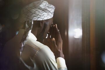 muslim man having worship and praying in islam ceremony in mosque - obrazy, fototapety, plakaty