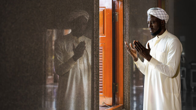 muslim man having worship and praying for allah blessing in islam ceremony in mosque during islamic ramadan period