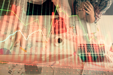 Fototapeta na wymiar Double exposure of man and woman working together and financial chart hologram drawing. market analysis concept. Computer background. Top View.