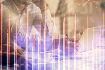 Multi exposure of man and woman working together and financial chart hologram. Business concept. Computer background.