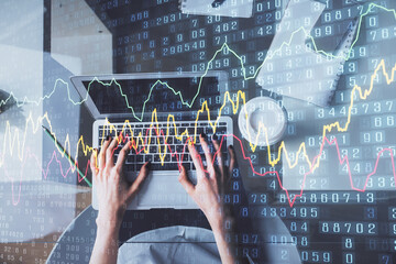 Double exposure of woman hands working on computer and forex chart hologram drawing. Top View. Financial analysis concept.