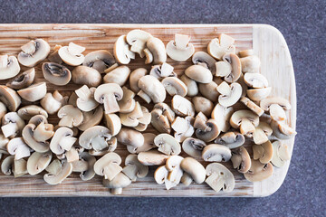 simple food ingredients, champignon mushrooms cut in halves on chopping board