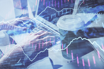 Double exposure of woman hands typing on computer and forex chart hologram drawing. Stock market invest concept.