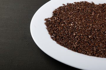 Chocolate sprinkles background. View of granulated chocolate.