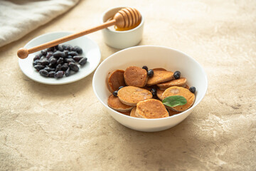 Mini pancakes with honey berries and honey. Tasty, healthy, beautiful.