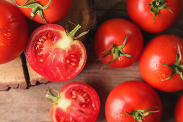 Fresh ripe tomatoes on wooden table, flat lay