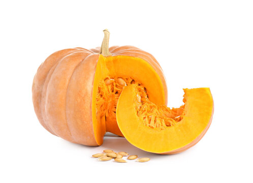 Cut ripe orange pumpkin and seeds on white background