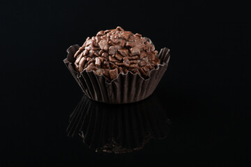 Typical brazilian brigadeiro isolated on black background