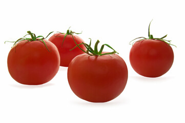 Four red ripe tomatoes on a white isolated background close up