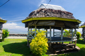 Closeup of a beach fale surrounded by the sea under the sunlight in Manase, Samoa © Matej Halouska/Wirestock