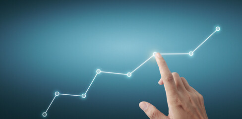 Hand touching a graphs of financial indicator  accounting market economy analysis chart