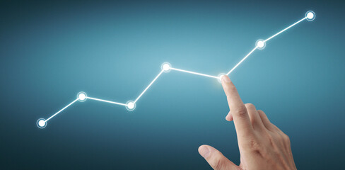 Hand touching a graphs of financial indicator  accounting market economy analysis chart