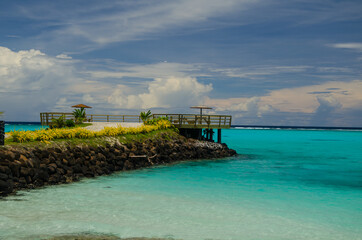 Stone pier surrounded by greenery and sea under the sunlight in the Savai'i Island, Samoa
