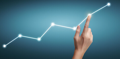 Hand touching a graphs of financial indicator  accounting market economy analysis chart