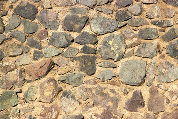 old stone wall fixed with cement mortar 