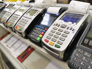 Multiple business credit card readers on your desk.