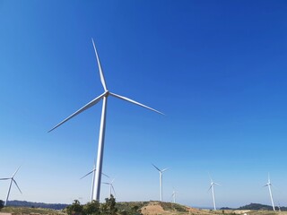 Wind turbines on beautiful summer on the mountain landscape. Green ecological power energy generation.