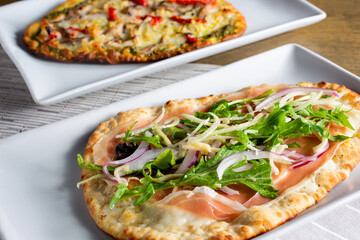 A view of two flatbread pizza appetizers.