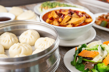 A view of several Chinese entrees on a table.