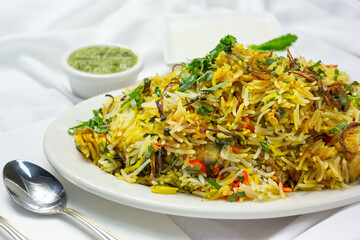 A view of a plate of chicken biryani.
