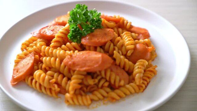 spiral or spirali pasta with tomato sauce and sausage - Italian food style