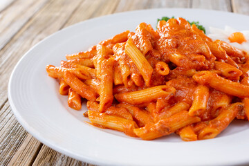 A view of a plate of penne pasta.