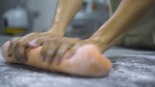 Chef preparing dough ontop of a table