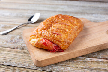 A view of a raspberry strudel, in a restaurant or kitchen setting.