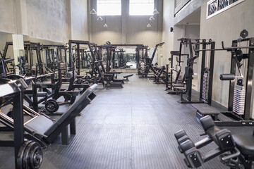 Gym with modern fitness equipment for fitness body workout.