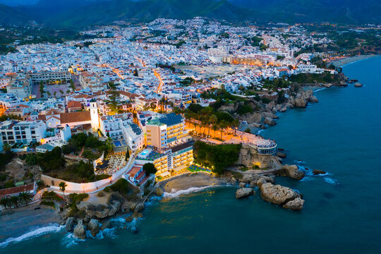 Aerial view of illuminated Nerja city at Mediterranean coast, Costa del Sol, Spain