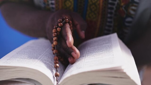 Inspirational bible verses recitation by black man closeup