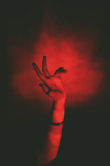 female hand in red light in horror style