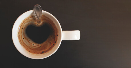 background with cup of coffee with heart-shaped foam
