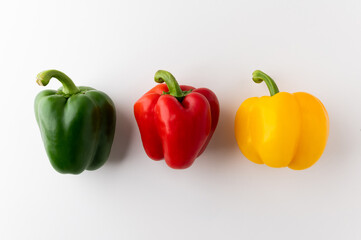 Colorful raw red yellow green of bell pepper above view on isolated white background. Healthy vegetables and food.