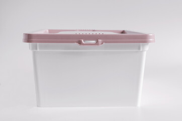 Plastic container with lid on white background side view