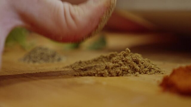 Putting finger into garnish spice. Dish decoration. Cooking  Muslim food