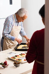 An old man making bread