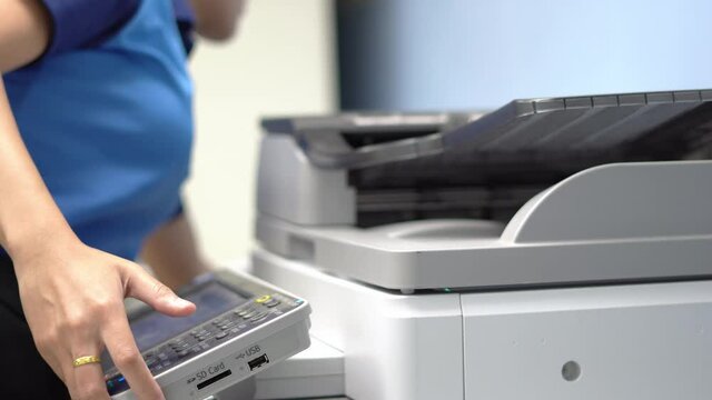 Female workers are working on documents by copying documents with a multifunction copier machine.