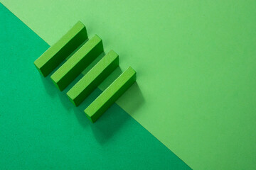 Top view shot of green wooden rectangles on the light and dark green background