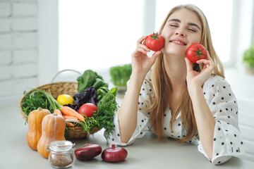 Beautiful young woman eating vegetables in the kitchen. Healthy food. Vegan salad. Diet. Diet concept. Healthy lifestyle. Cook at home. High quality photo.