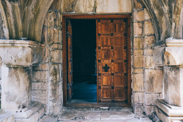 Fototapeta na wymiar Door in old medieval stone wall in a Georgian Motsameta Monastery, Kutaisi, Georgia. Unesco world heritage. Famous historical place Imereti.
